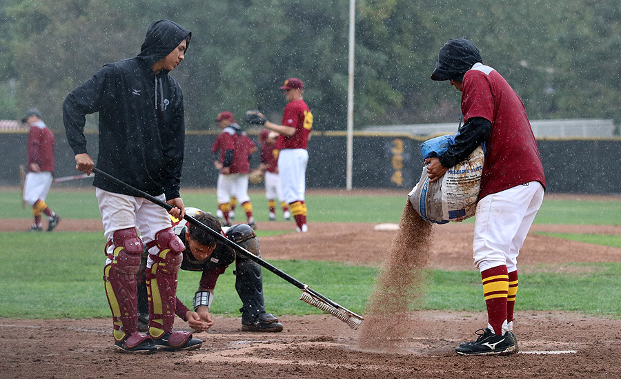 Players tried to revive the field, before the game was called in the 4th inning.