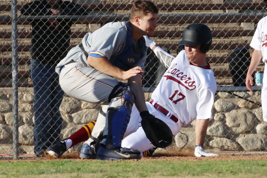 Lancer Daniel Netz slides into home for a run in a recent game, photo by Richard Quinton.