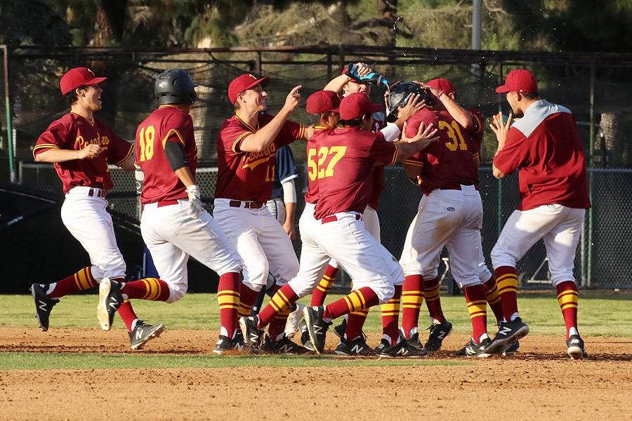 Teammates mob Lancer Tony Shue (31, right side) following his walk-off hit Monday in defeating El Camino 6-5, photo by Richard Quinton.