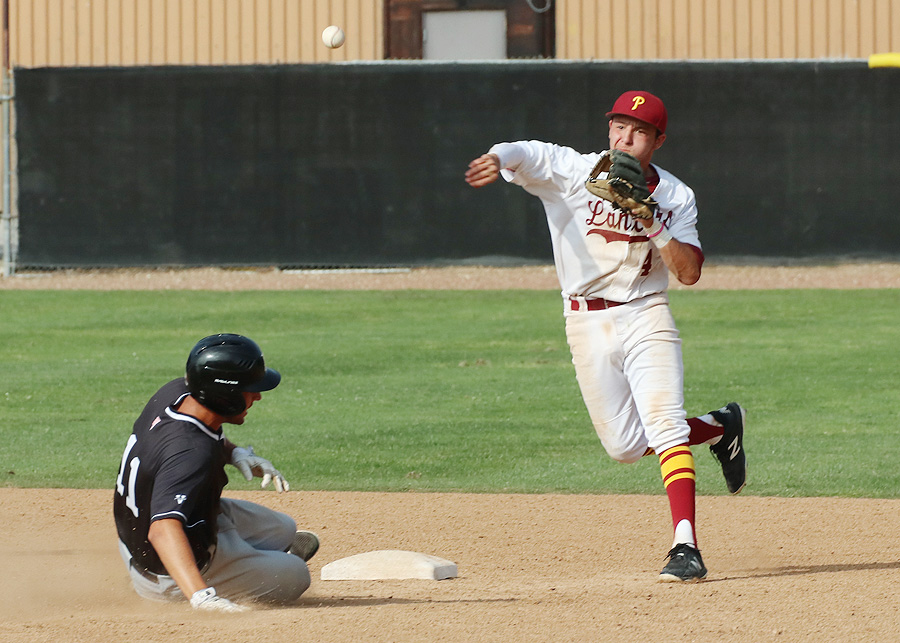 Lancers freshamn second baseman Ryan Lewis turns a double play in a recent game, photo by Richard Quinton.