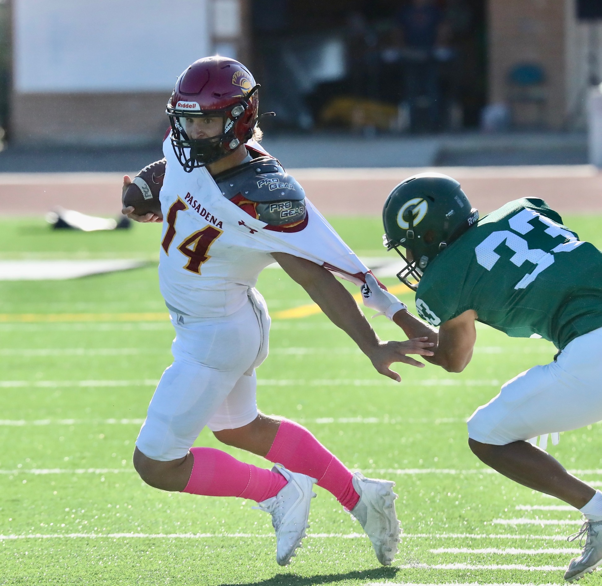 Lancers receiver Ivan Ostry tries to elude a tackler grabbing his jersey during PCC's loss at Grossmont College on Saturday (photo by Michael Watkins).