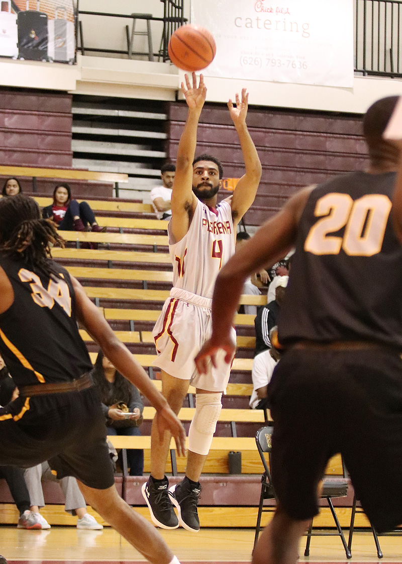 Justin Brown fires up one of his seven 3-point baskets in PCC's win Friday night, photo by Richard Quinton.