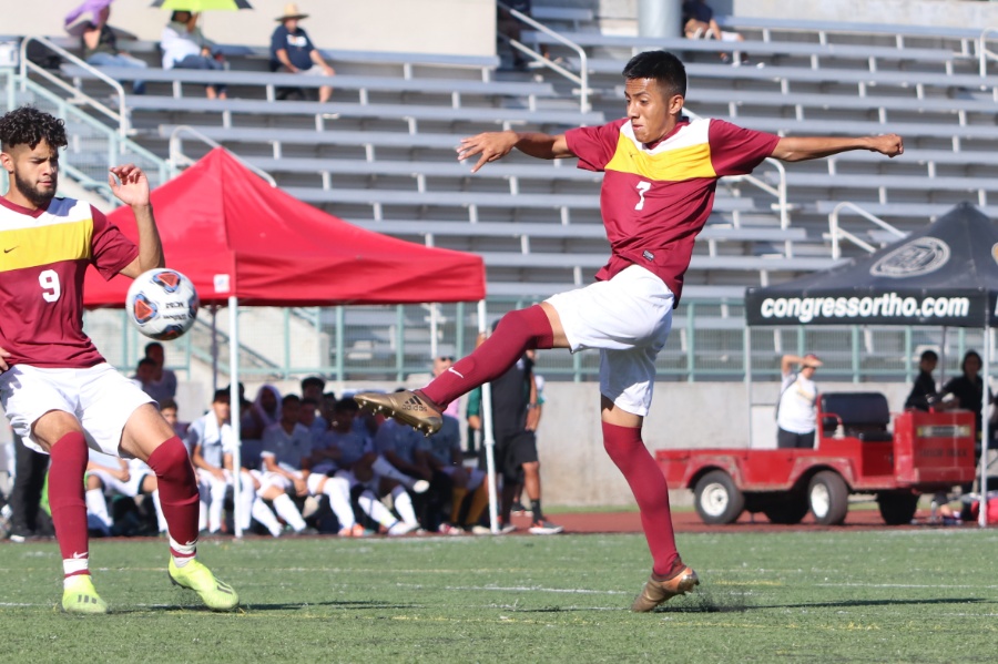 Alexis Guzman drives a shot with David Vazquez-Mena looking on during PCC's 3-2 win over East LA at Robinson Stadium Friday, photo by Richard Quinton.