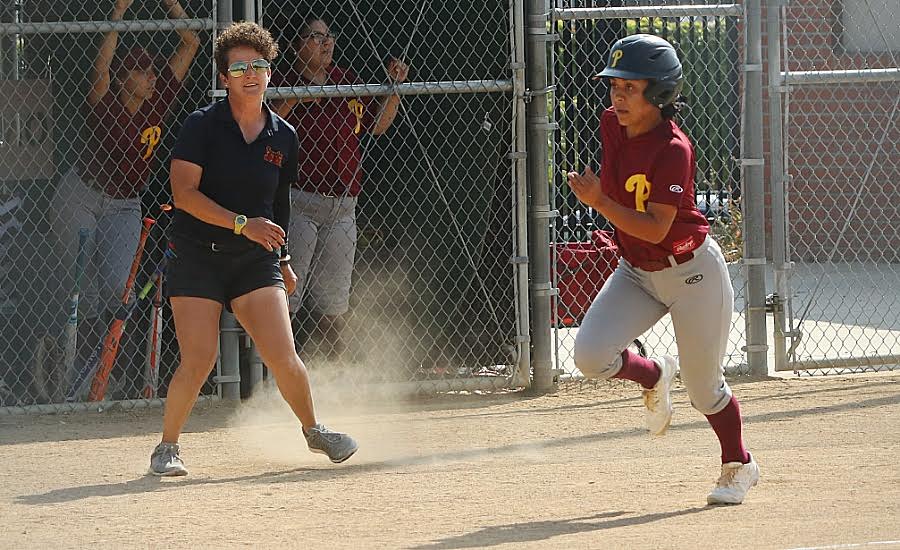 PCC softball coach Monica Tantlinger coaching third with Jeneve Medrano on her way home during the team's win over Orange Coast on Monday, photo by Richard Quinton.