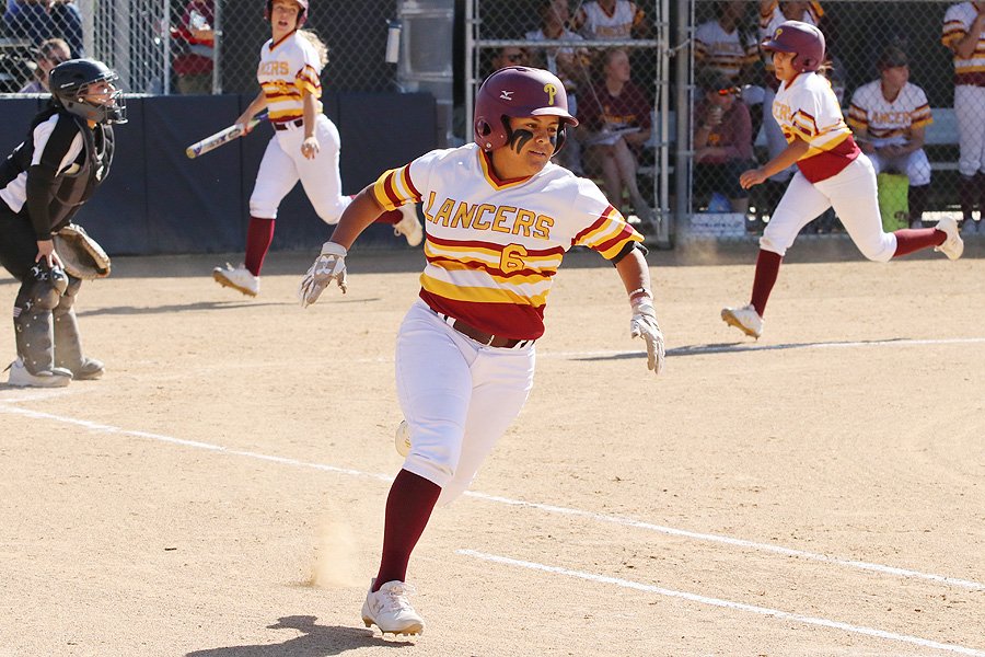 Lancer Kaylee Medrano runs to first during the Lancers win Tuesday at Robinson Park, photo by Richard Quinton.