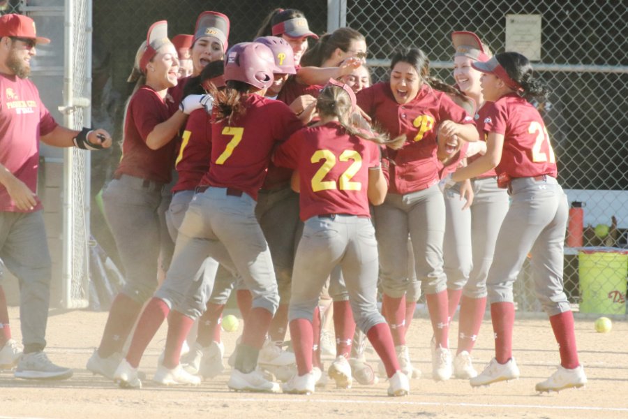 The Lancers mob Amanda Flores after her game-winning hit in the 13th inning v. Chaffey on Tuesday, photo by Richard Quinton.