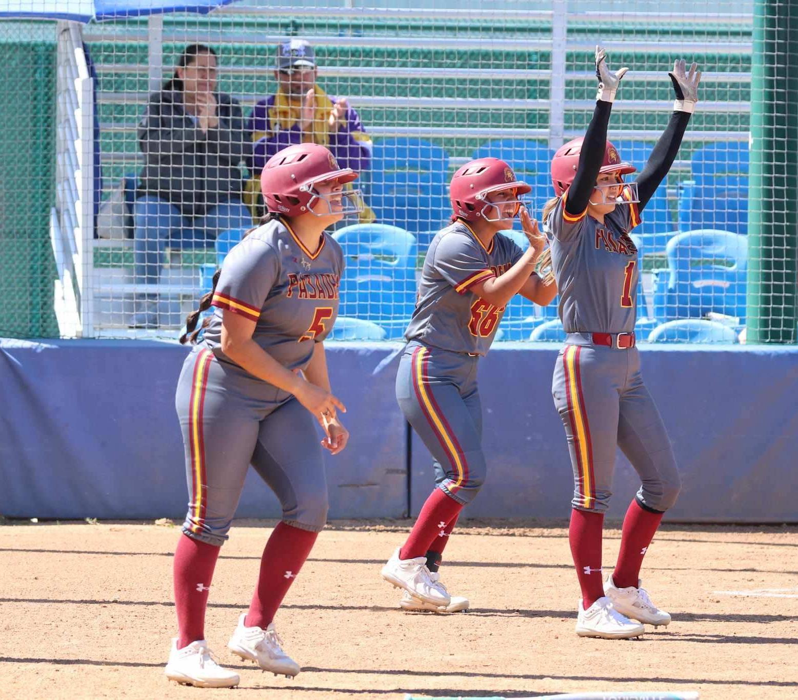 Marcella Ordonez (left), Gigi Leyva, and Breanna Rodriguez (right) cheer on teammate Jaime Harris after she doubled all three runners in during PCC's win at Cerritos (photo by Richard Quinton).