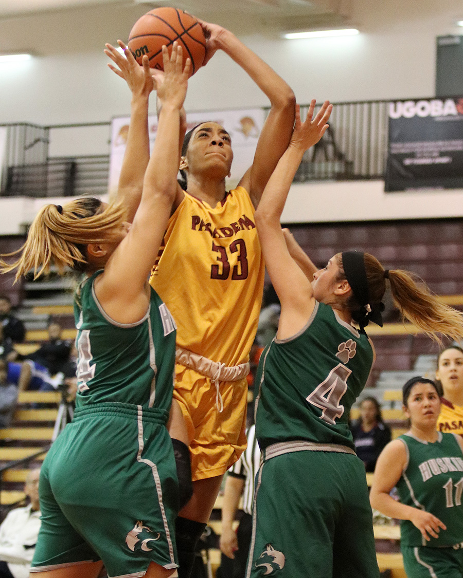 Lancer Kailyn Gideon goes up for a shot between defenders Wednesday night in a loss to East Los Angeles, photo by Richard Quinton.
