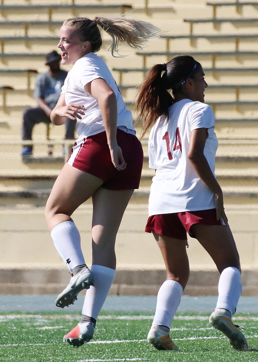 Lancer Katy Coats shows her excitement upon scoring her first collegiate goal in the PCC women's soccer team's 2018 season opener at LA Valley College Thursday (going by Selena Macias Farias with a high five), photo by Richard Quinton.