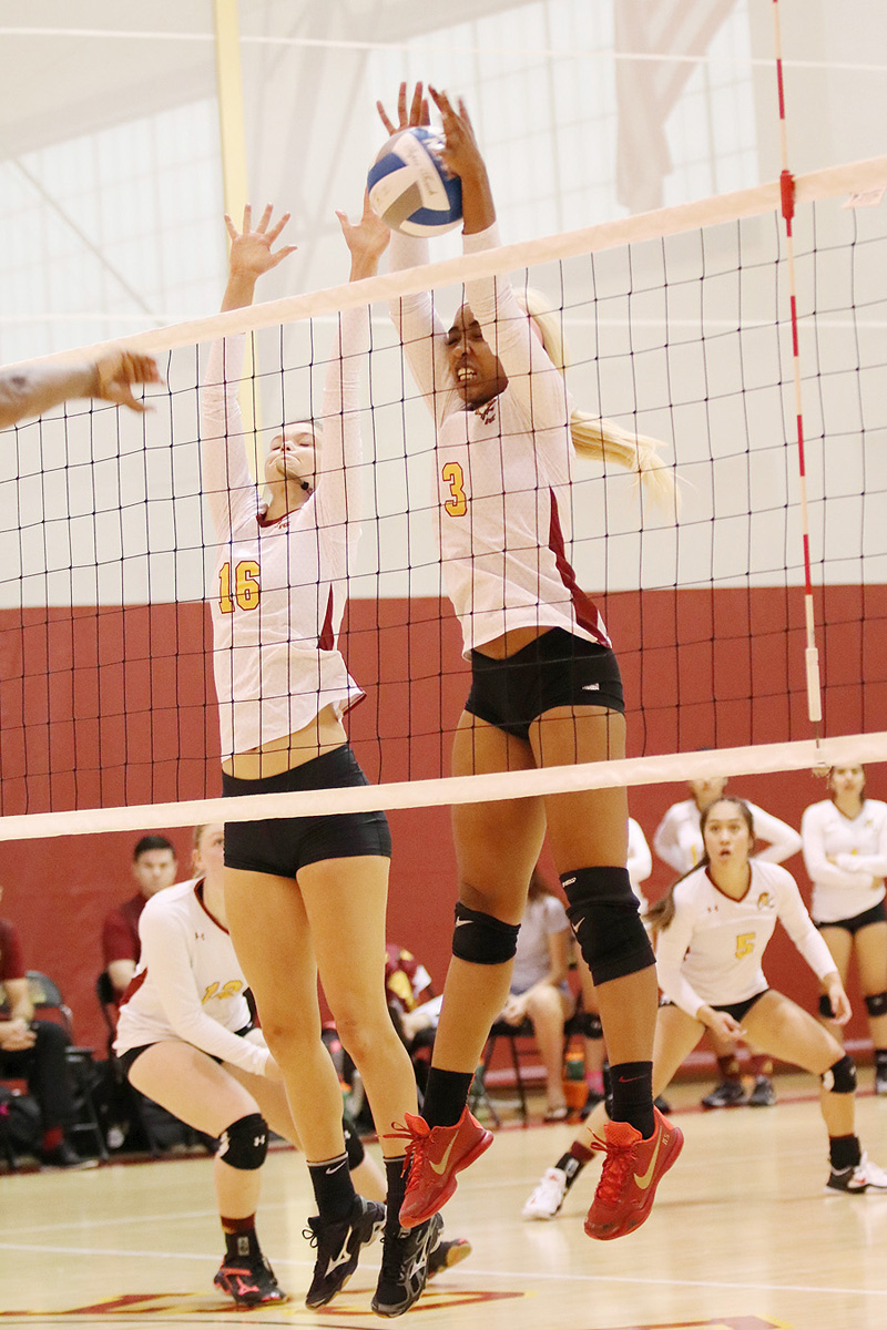 Rachel Johnson (left) and Kendall Schmedes (right) go up for a block during PCC's four-set win over Riverside at Hutto-Patterson Gym Saturday.
