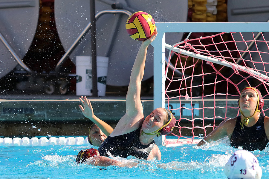 Camila Grases goes up high for a field block in front of PCC goalie Mariah York in a recent match, photo by Richard Quinton.