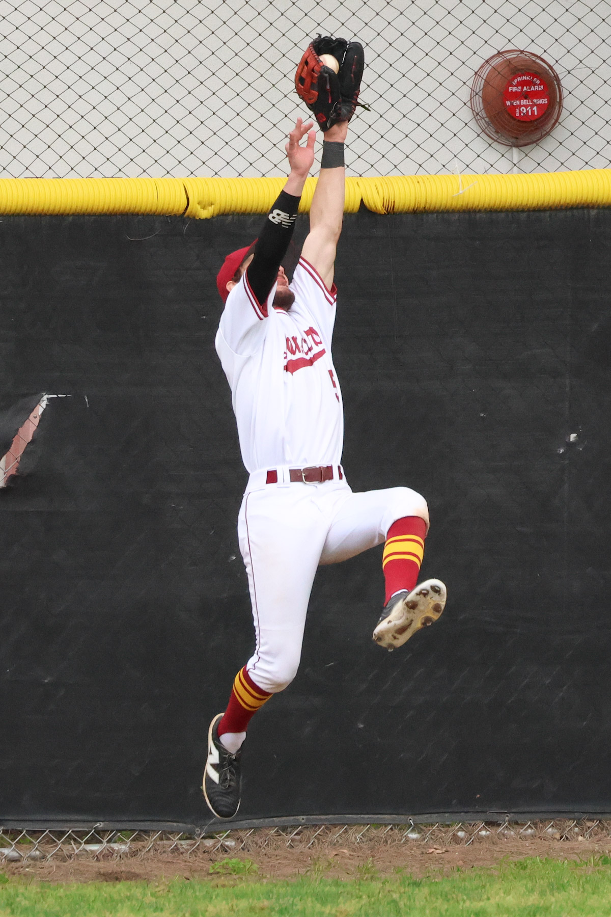 Evan Coad robs a home run during PCC's victory (photo by Richard Quinton).
