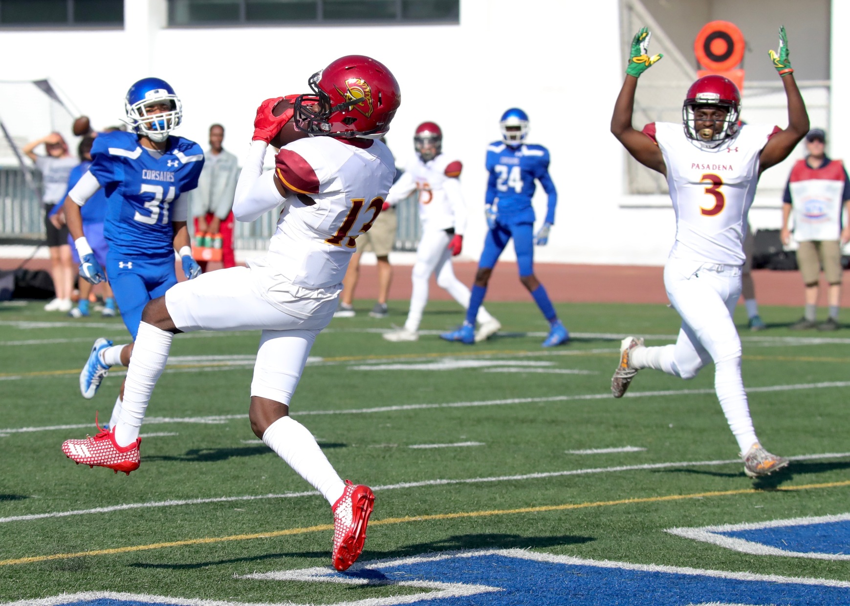 Ahmad Lipscomb hauls in a touchdown pass from Edward Norton as teammate Jabari Kindle plays referee on the play during PCC's rout at Santa Monica College Saturday afternoon, photo by Michael Watkins.