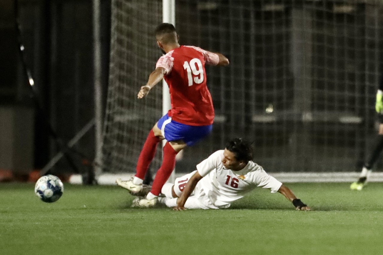 Diego Flores (16) makes the slide tackle on a LA City player in PCC's loss on Tuesday night (photo by Michael Watkins).