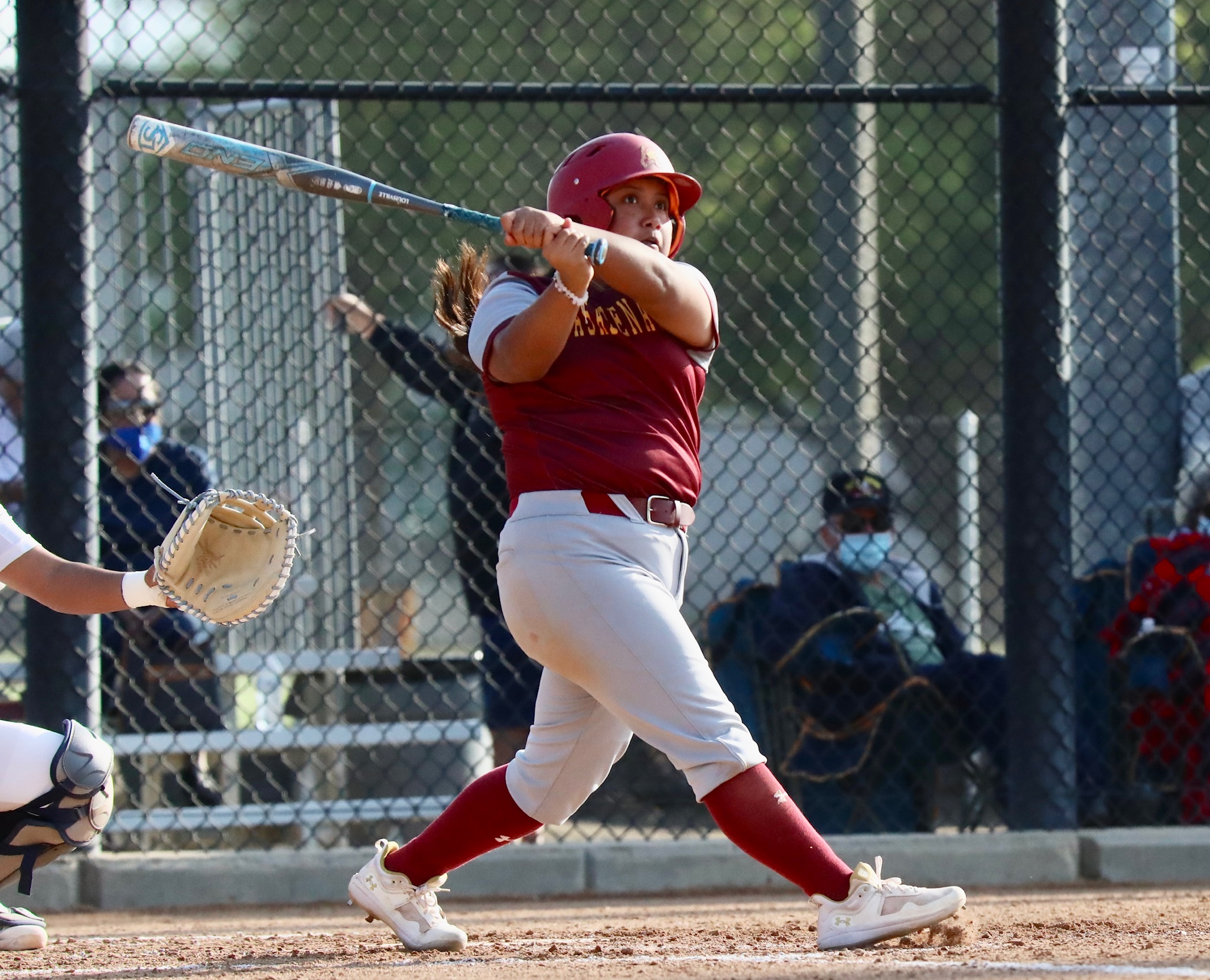 Vianey Orozco ripping a line drive in a recent game (photo by Michael Watkins, Athletics).