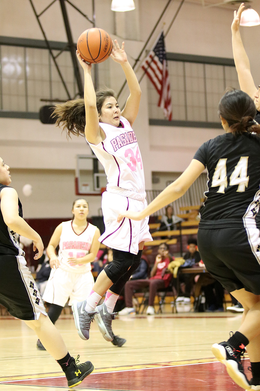 Lancer Elise Ortega, wearing PCC's White/Pink jersey for Coaches v. Cancer Night, attempts a pass against Rio Hondo on Friday night, photo by Richard Quinton.