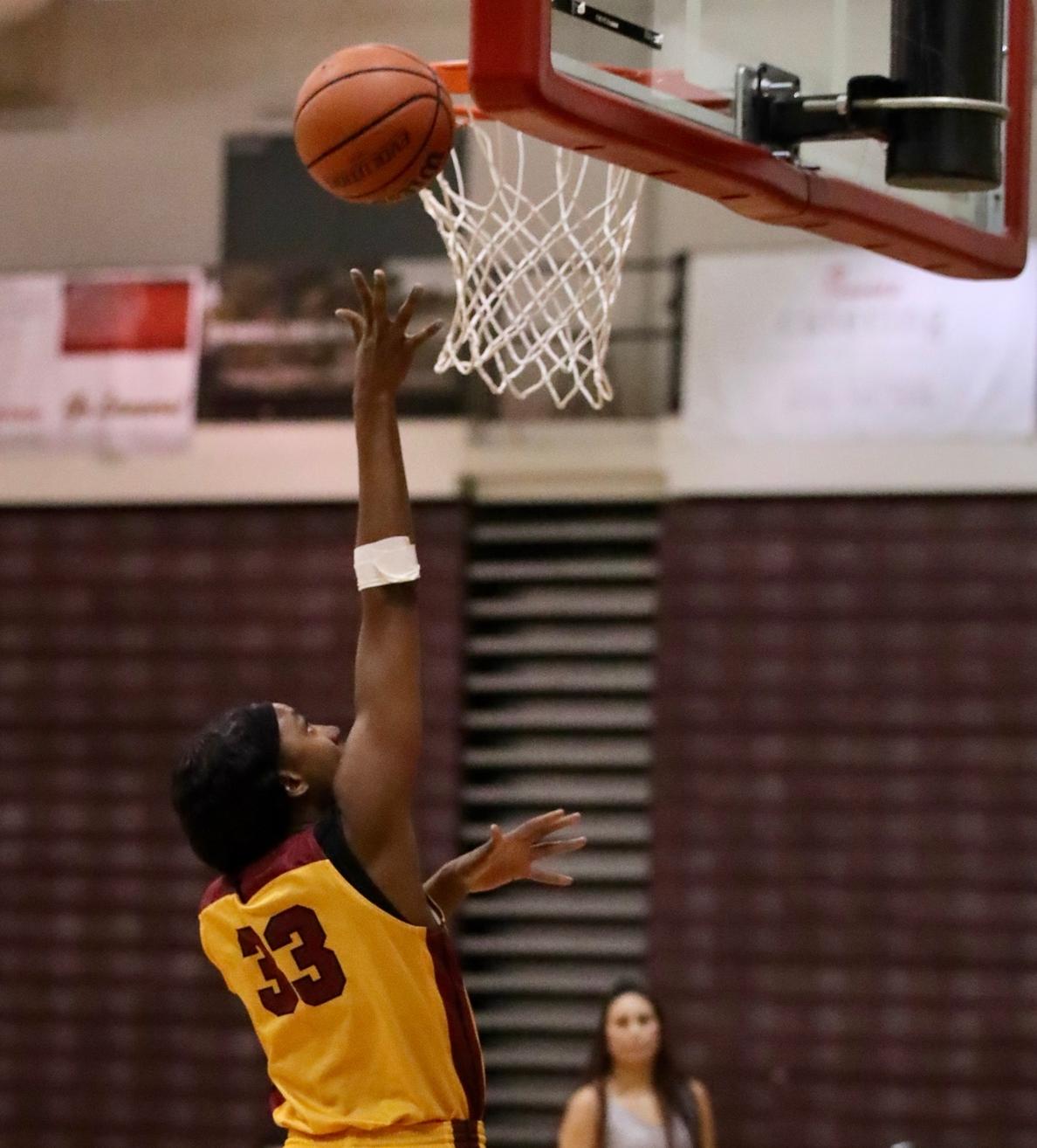 Dariel Johnson goes up for a layup in a recent game, photo by Michael Watkins.