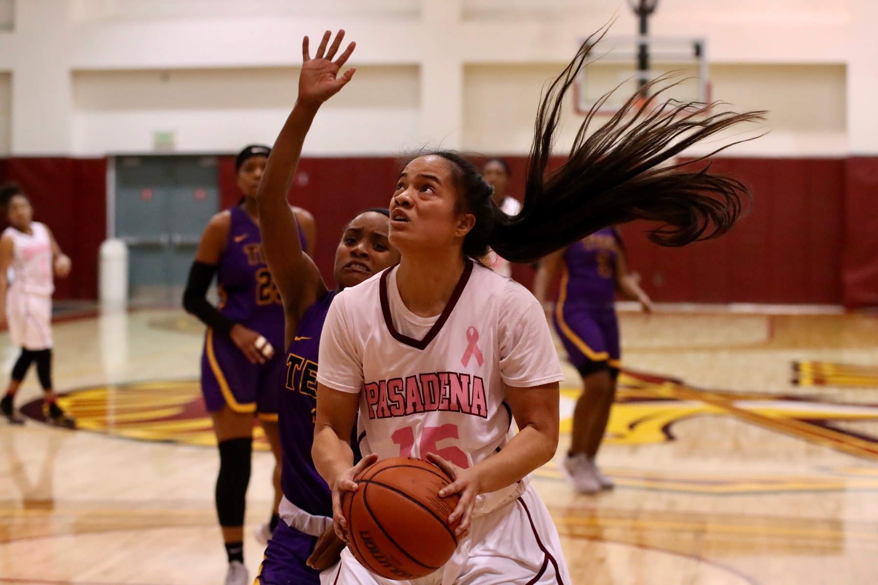 Merina Latu, wearing PCC's Cancer Awareness home jersey, goes to the hoop during Wednesday's win, photo by Michael Watkins.