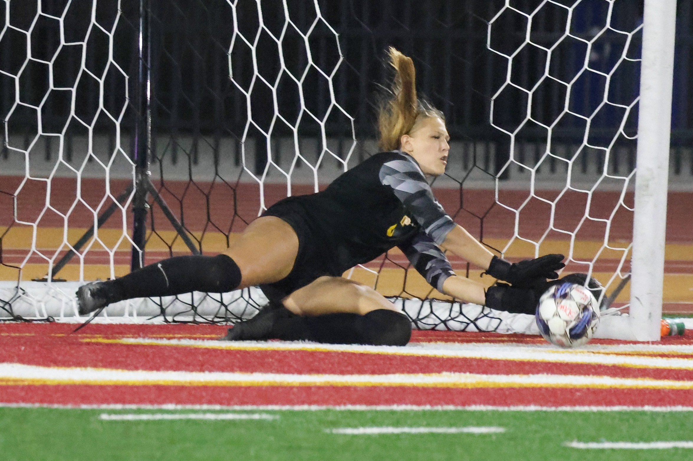 Francesca Agliolo makes the big penalty kick save in PCC's win at Saddleback (photo by Richard Quinton).