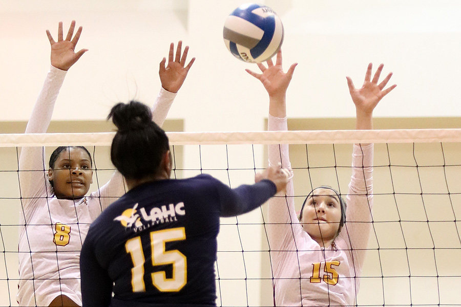 Lancers Jada O'Mally (left) and Janell Currier (right) try to block an opposing attack during PCC's 3-set win over LA Harbor Wednesday evening, photo by Richard Quinton.