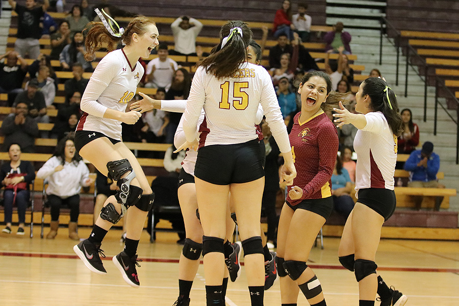 Lancer Danielle Johnson (left) jumps in excitement with her teammates as PCC swept Mt. San Antonio on Saturday, photo by Richard Quinton.