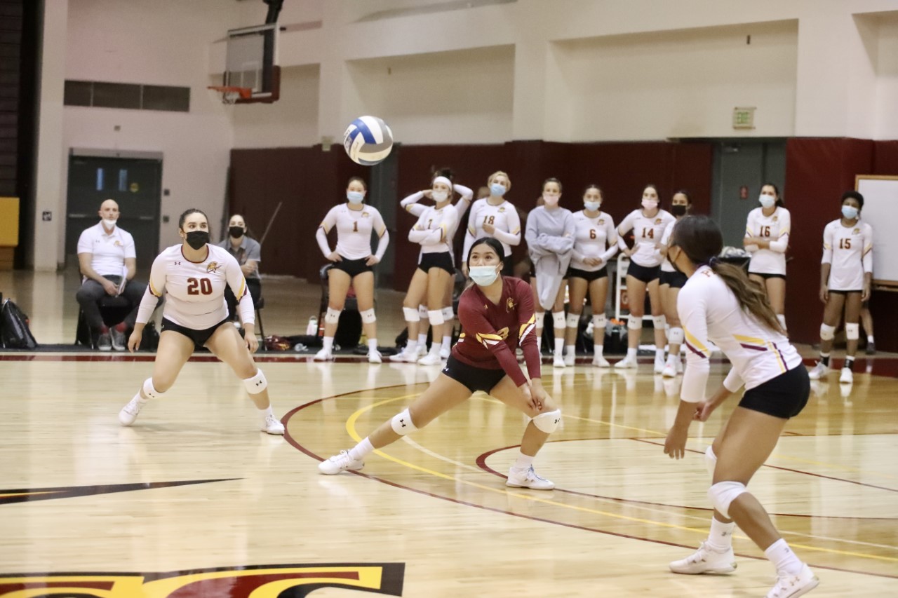 Libero Kei'ana Pascua gets the dig here with teammate Nayeli SalasOrtiz (20) and Coach Mike Terrill (seated white polo) looking on in PCC 4-set win Wednesday night, photo by Michael Watkins.