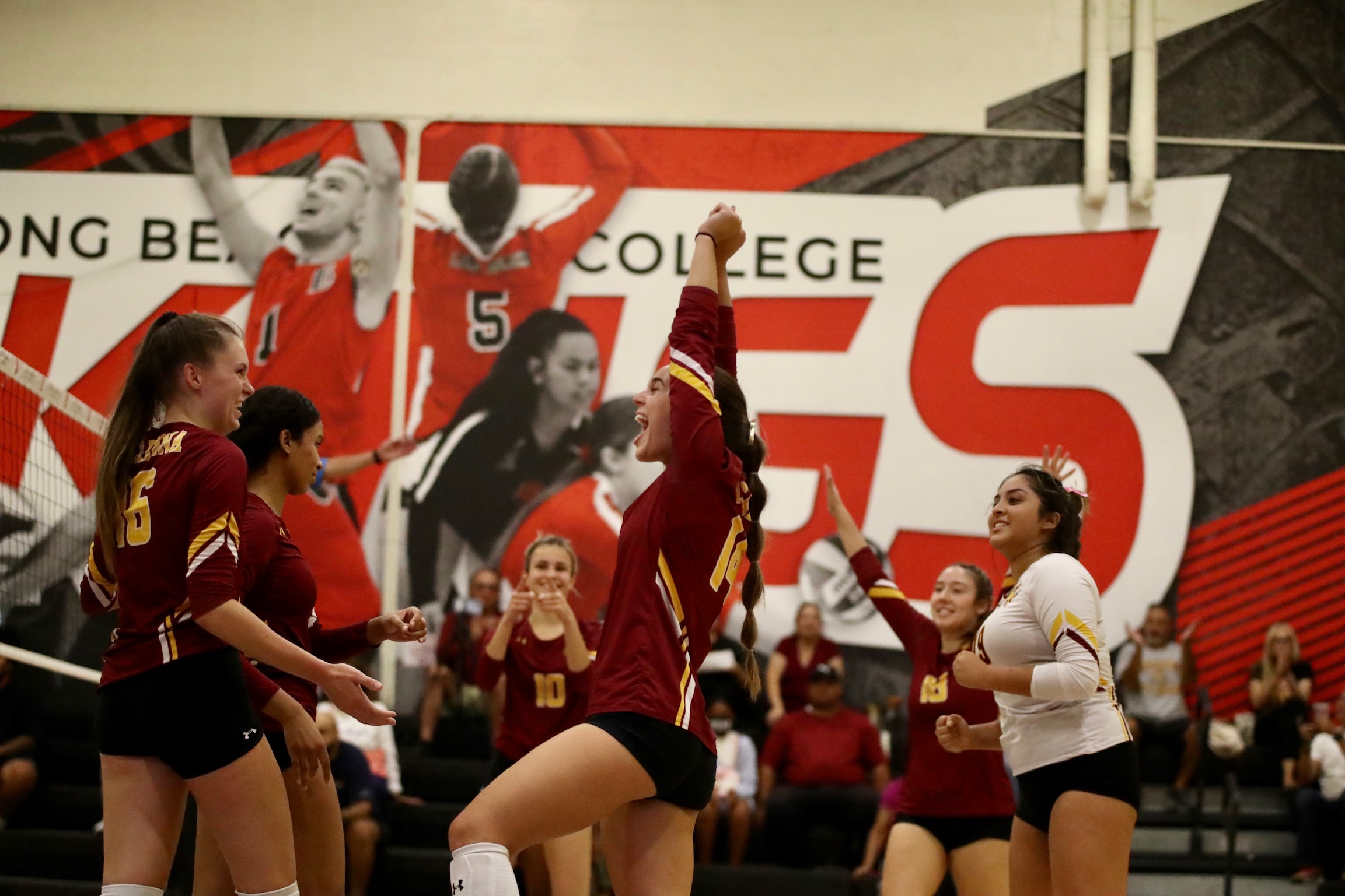 The Lancers celebrate a point at Long Beach's Hall of Champions court in Friday's win (photo by Michael Watkins).