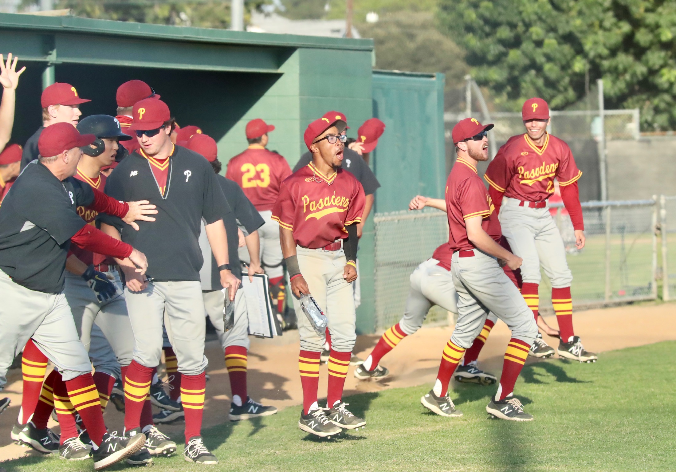 The Lancers dugout reacts to the ninth-inning home runs in PCC's win at Long Beach City College on Thursday (photo by Michael Watkins, Athletics).