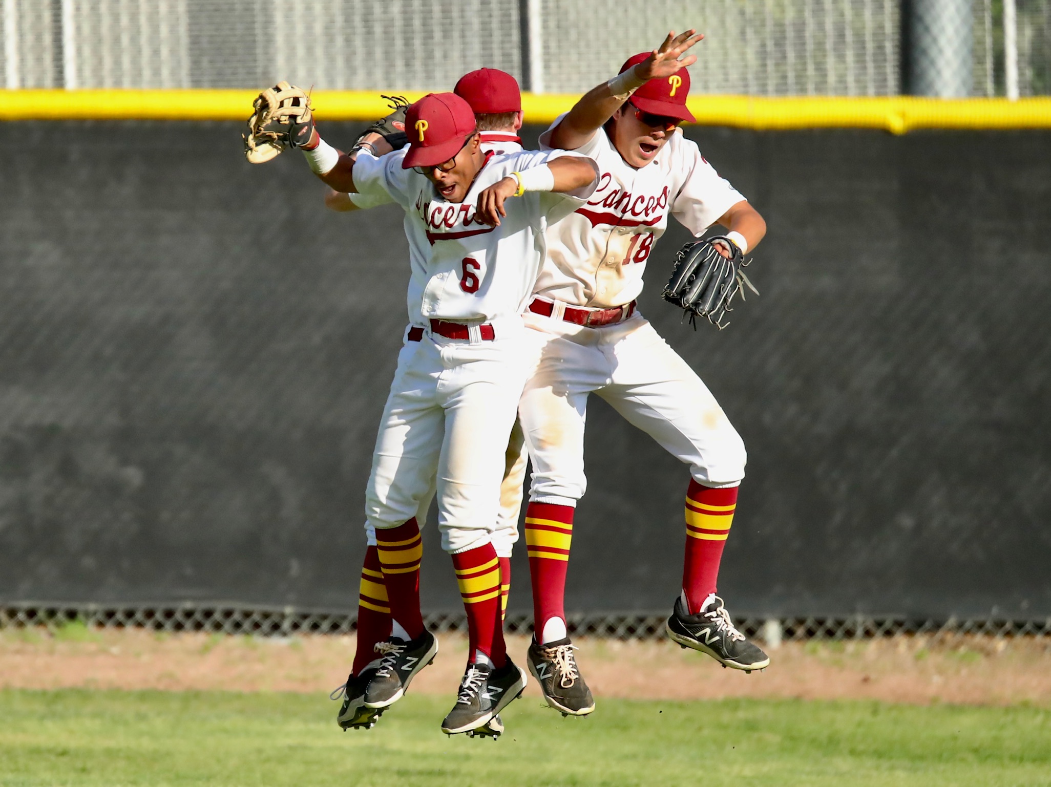 PCC's outfield of Aryonis Harrison (#6), Jakob Guardado (right) and Max Blessinger do a celebratory leap bump as the Lancers won their ninth straight on Thursday (photo by Michael Watkins, PCC Athletics).