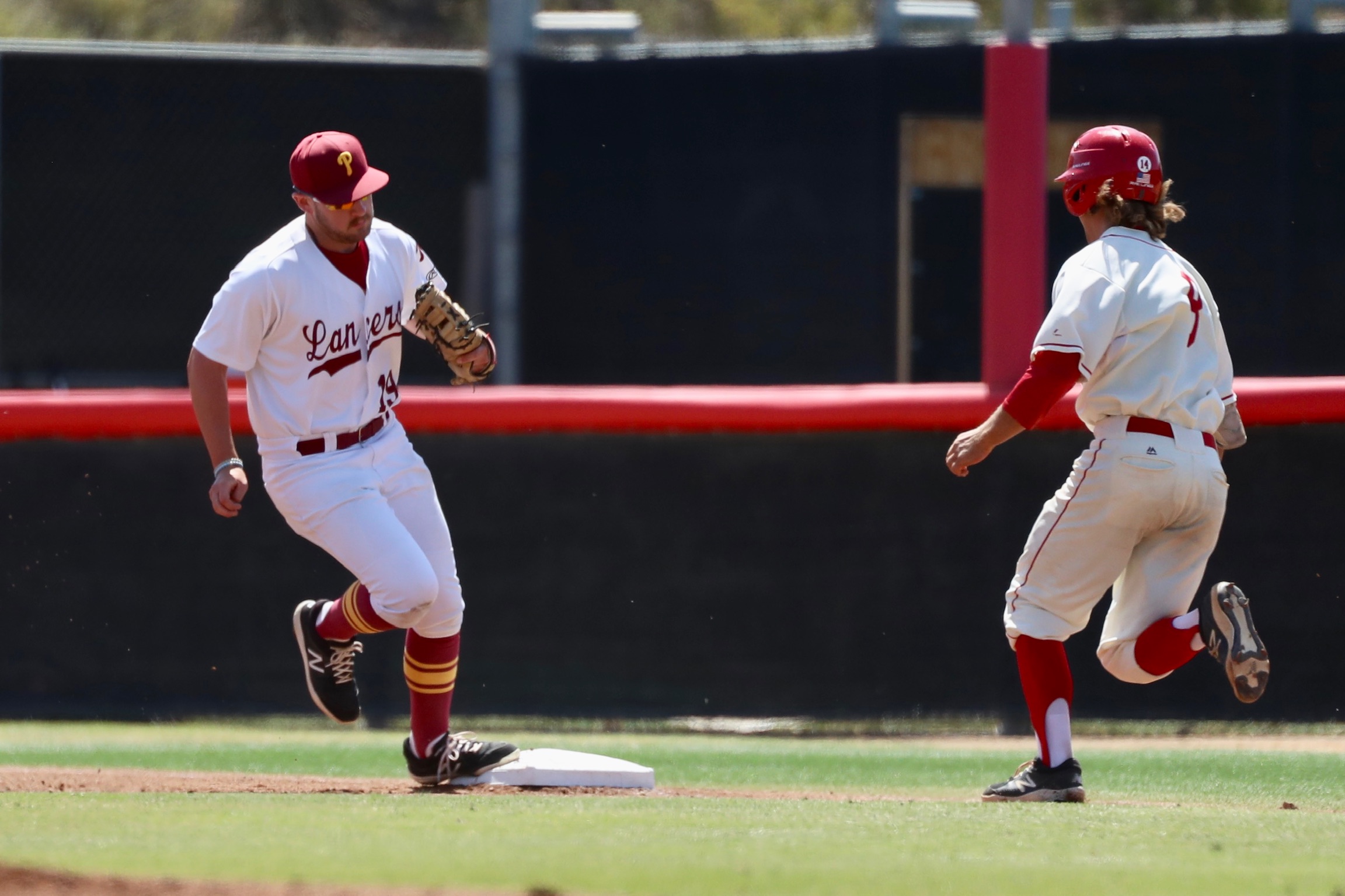 Lancers first baseman Jake Trabbie beats the runner to the bag during Saturday's Regionals at Palomar. (photo by Michael Watkins, Athletics).