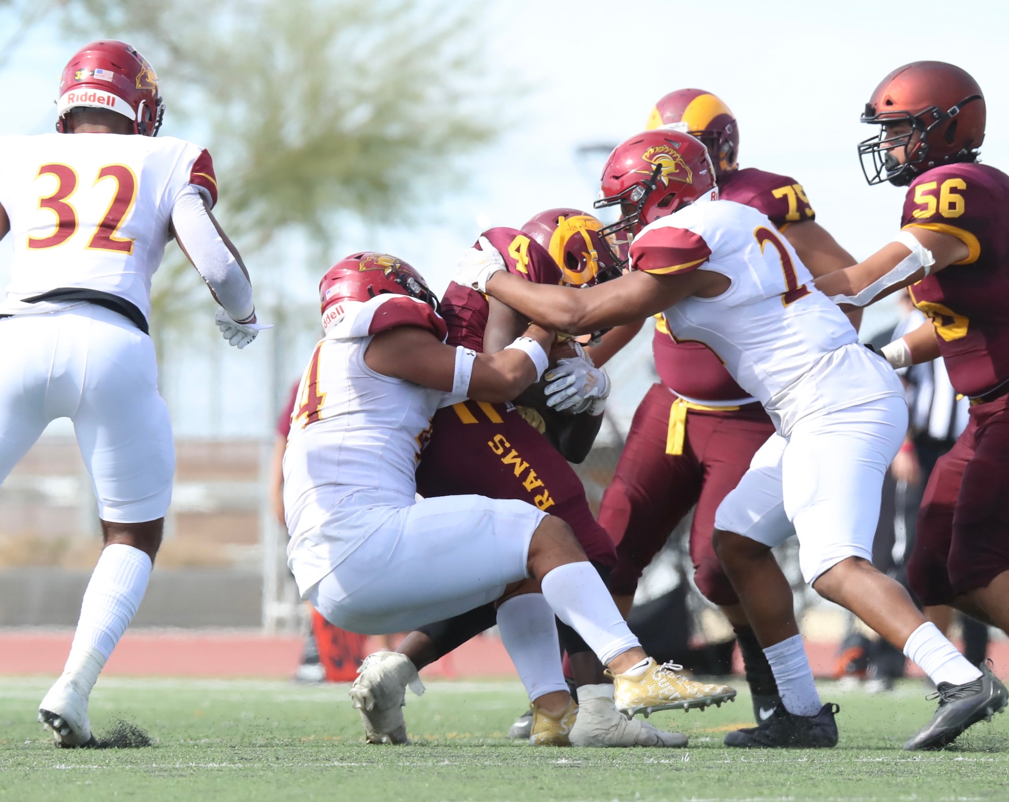 The PCC defense swarms on a tackle during the Lancers win over Victor Valley at Adelanto High School on Saturday (photo by Michael Watkins).