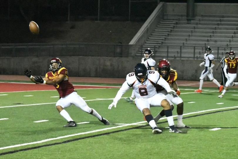 With Kaydon Spens defending the Citrus receiver, Osvaldo Raigosa goes after the interception in Saturday's night win over Citrus at Robinson Stadium (photo by Chris Cordova).