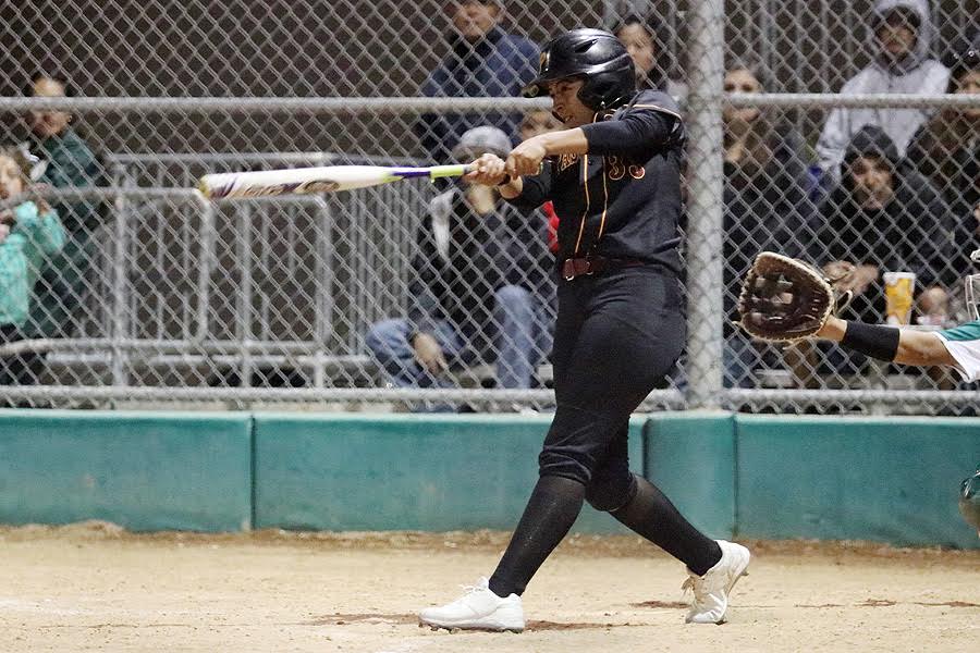 Lancer Brittany Gonzales finishes her 3-RBI double swing at East Los Angeles College Thursday night, photo by Richard Quinton.