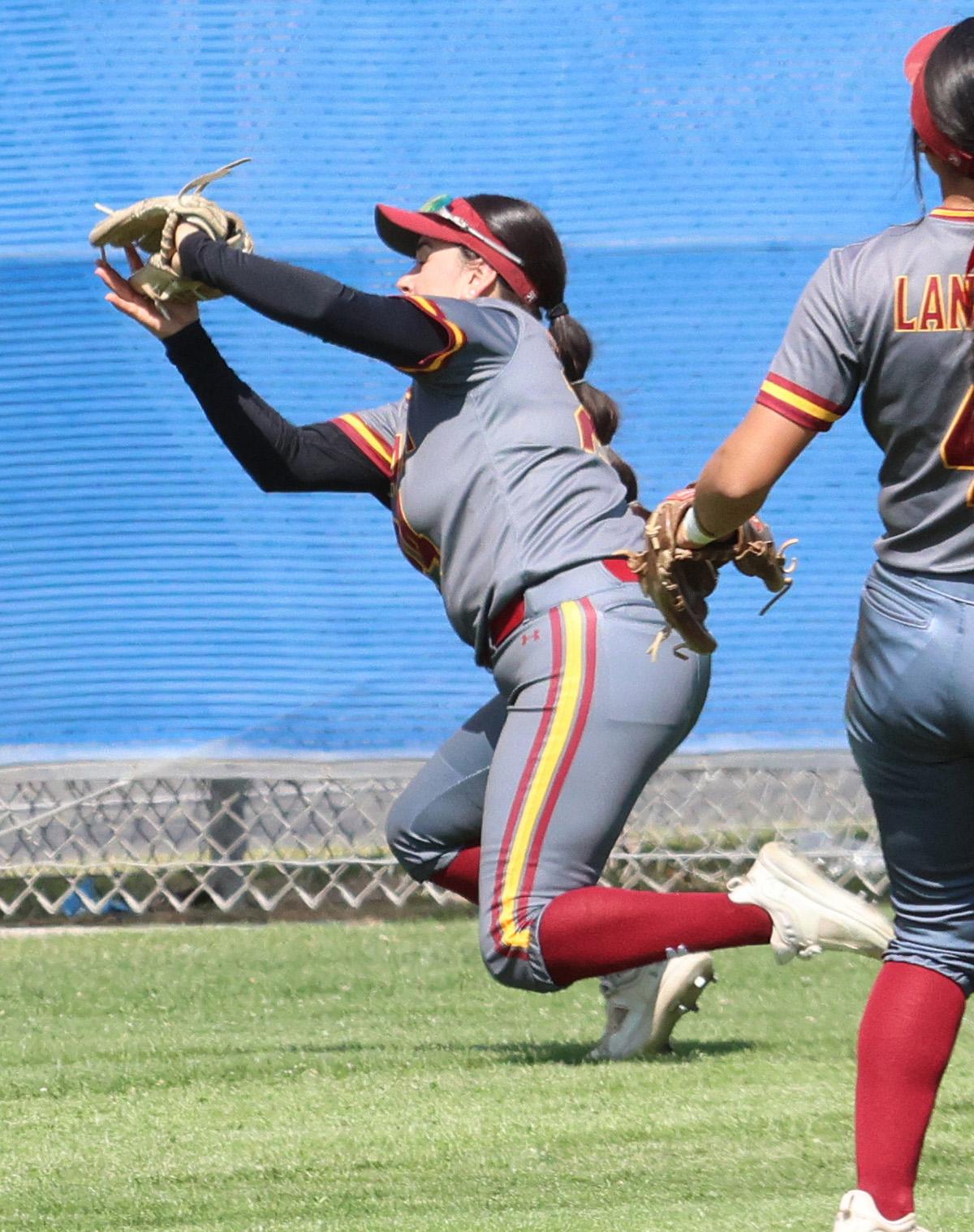 Olivia Nanez makes a great diving catch on this ball in game 1 of the Lancers regional playof series at Cypress College on Friday (photo by Richard Quinton).