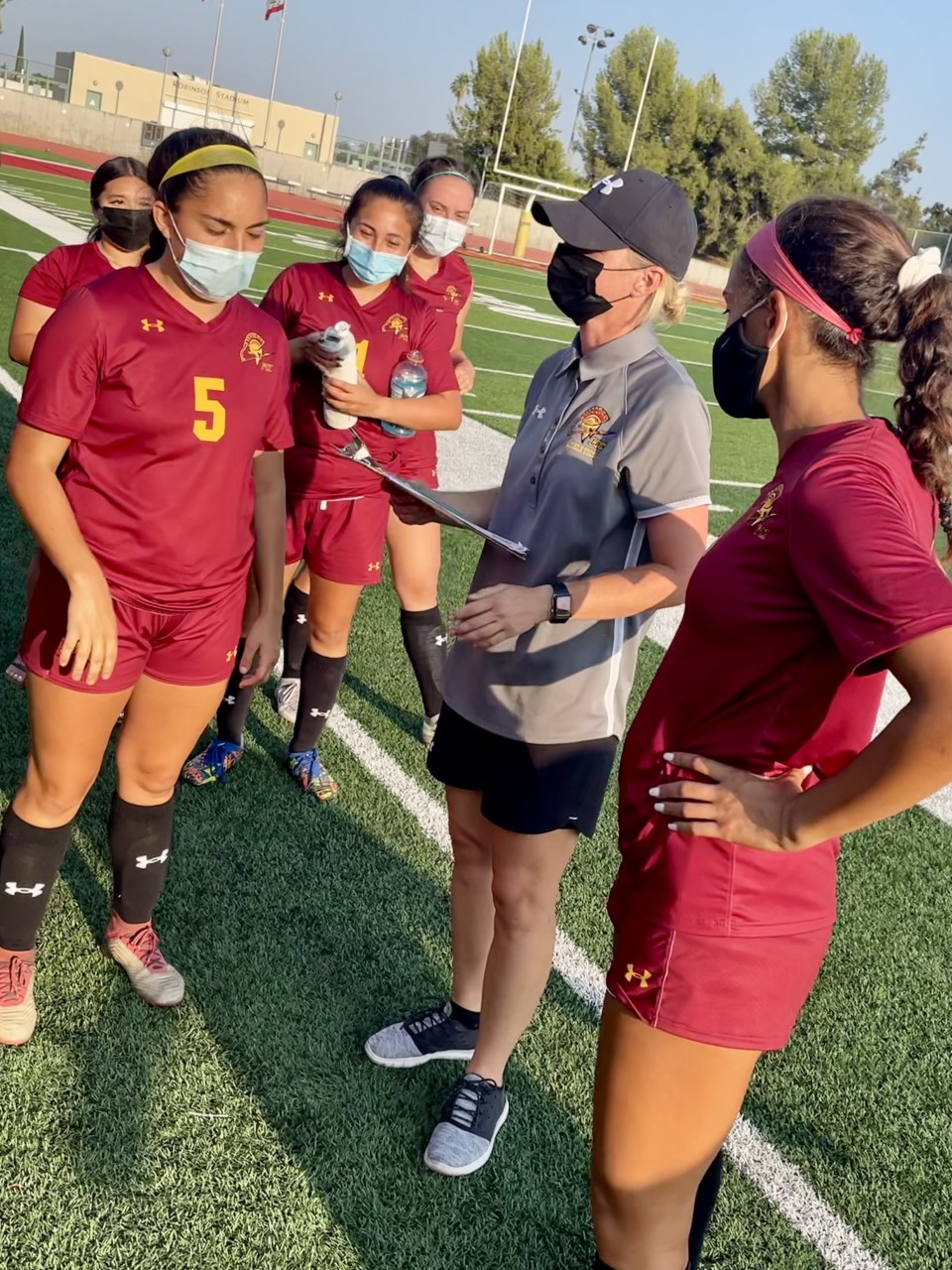 Terryn Soelberg collected her first head coaching victory at PCC and talks to the players after the contest, photo by Britney Lopez.